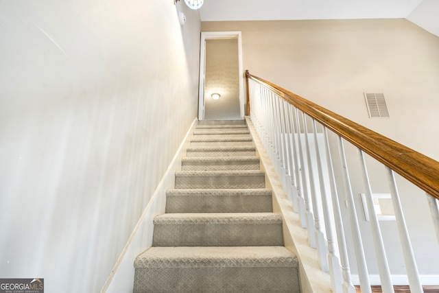 stairs with vaulted ceiling