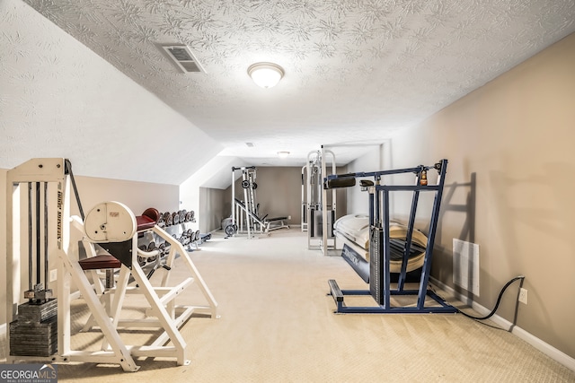 workout area with vaulted ceiling, a textured ceiling, and light colored carpet