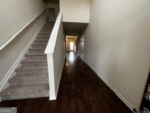 stairway with baseboards and wood finished floors