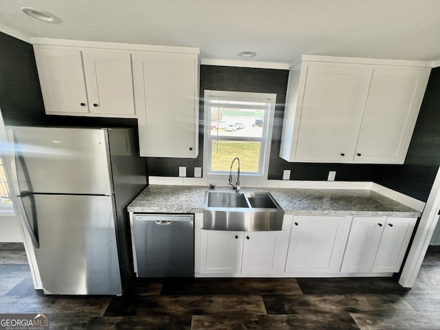 kitchen with sink, dark hardwood / wood-style floors, white cabinets, and stainless steel appliances