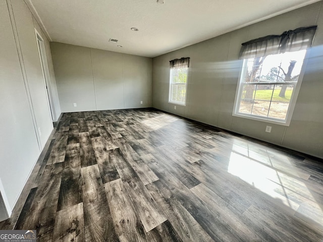 unfurnished room with hardwood / wood-style flooring