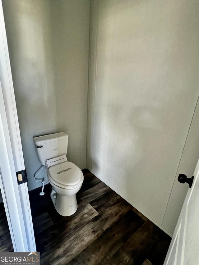 bathroom featuring wood-type flooring and toilet