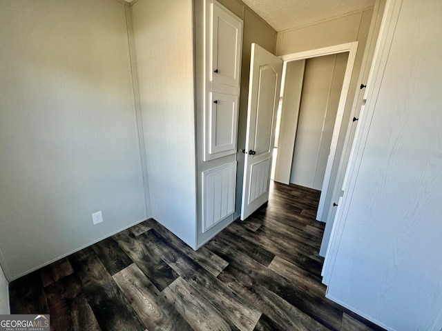 corridor featuring dark wood-type flooring