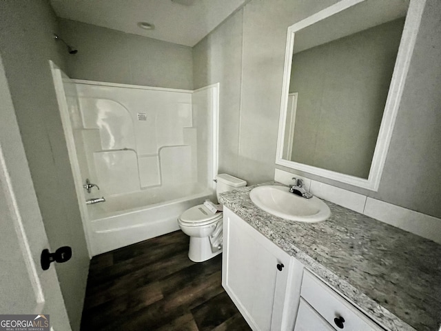 full bathroom with vanity, tub / shower combination, toilet, and hardwood / wood-style floors