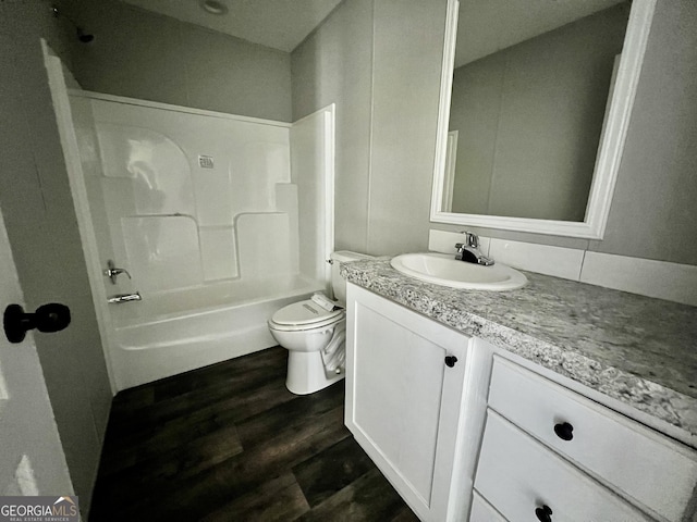 full bathroom featuring shower / bathtub combination, vanity, toilet, and hardwood / wood-style floors