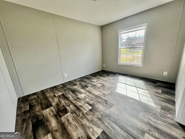 unfurnished room featuring dark hardwood / wood-style floors