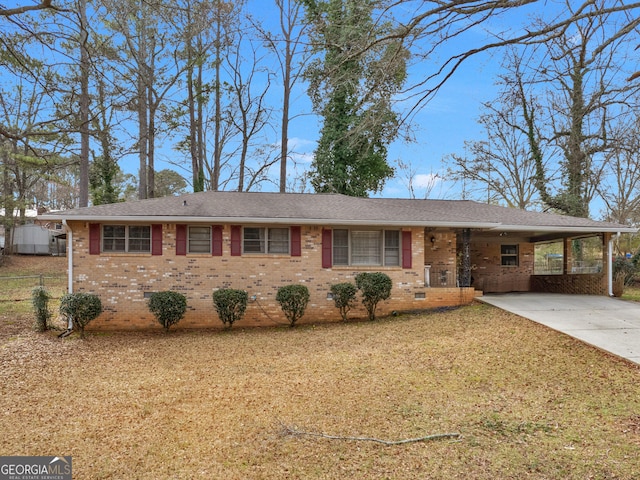 ranch-style home with a front lawn and a carport