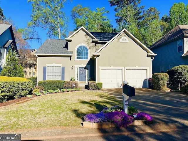 traditional-style home featuring an attached garage, driveway, a front lawn, and stucco siding