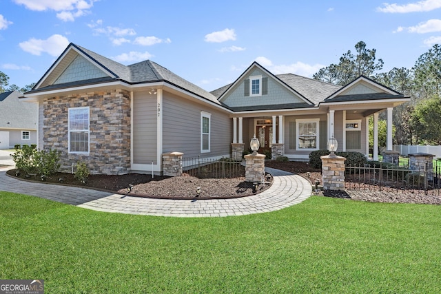 craftsman inspired home featuring covered porch and a front lawn