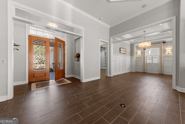 foyer featuring a notable chandelier, crown molding, and dark hardwood / wood-style floors