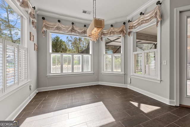 unfurnished dining area featuring ornamental molding and plenty of natural light