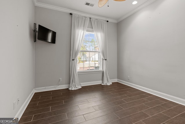 empty room with dark wood-type flooring, crown molding, and ceiling fan