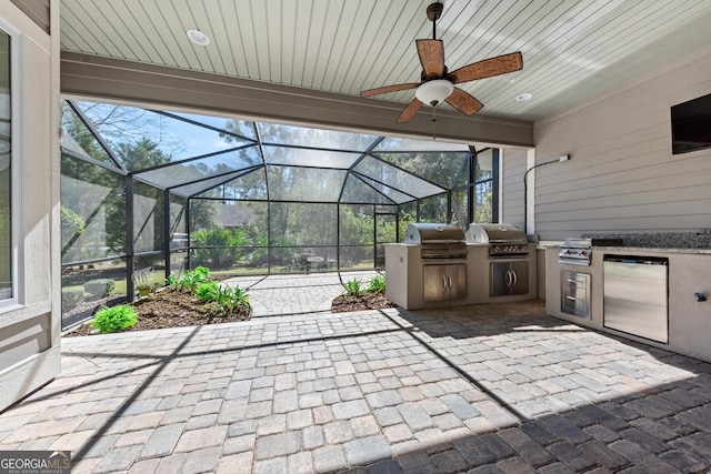 view of patio with area for grilling and a grill