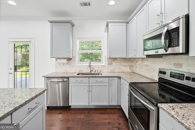 868 Still Hill Ln, Lawrenceville, GA 30045 - kitchen featuring appliances with stainless steel finishes, plenty of natural light, dark wood-type flooring, recessed lighting, and crown molding