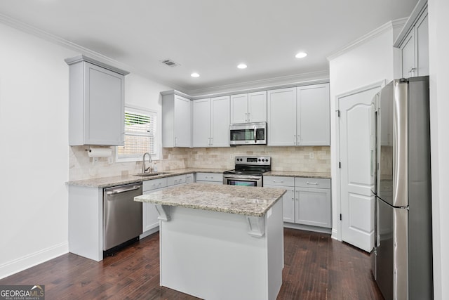 868 Still Hill Ln, Lawrenceville, GA 30045 - kitchen with appliances with stainless steel finishes, dark wood-style floors, crown molding, decorative backsplash, and recessed lighting