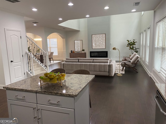 868 Still Hill Ln, Lawrenceville, GA 30045 - kitchen with arched walkways, dishwasher, a kitchen island, dark wood-style flooring, and recessed lighting
