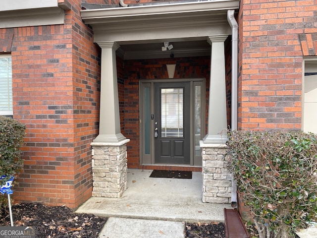 property entrance featuring brick siding