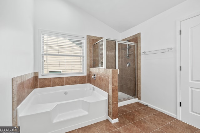 868 Still Hill Ln, Lawrenceville, GA 30045 - bathroom featuring a garden tub, lofted ceiling, a shower stall, and tile patterned flooring
