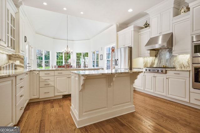 kitchen featuring light hardwood / wood-style flooring, decorative light fixtures, stainless steel appliances, kitchen peninsula, and white cabinets