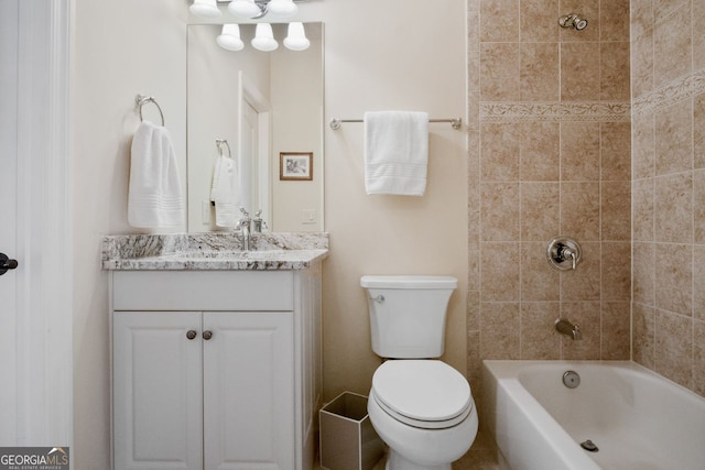 full bathroom with toilet, vanity, and tiled shower / bath combo