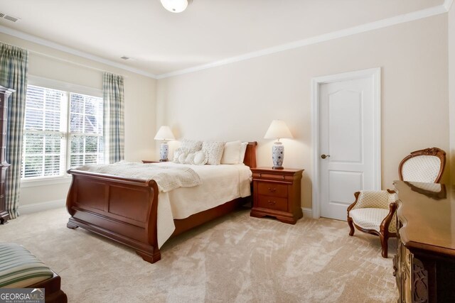 carpeted bedroom featuring crown molding