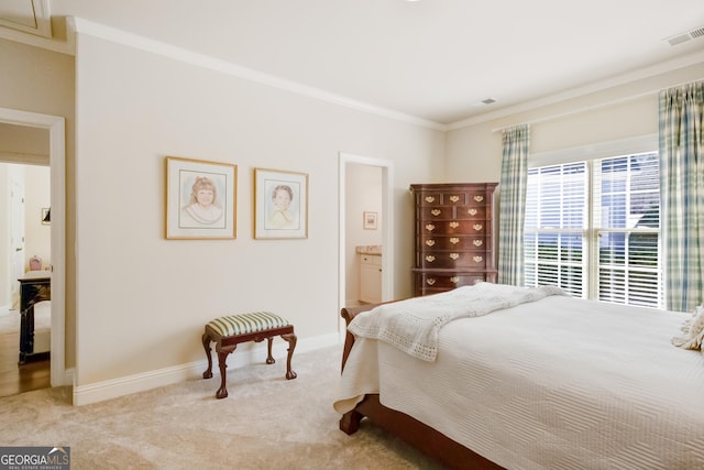 carpeted bedroom featuring ensuite bath and ornamental molding