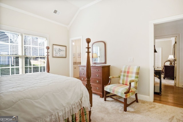 bedroom featuring ornamental molding, vaulted ceiling, and light carpet