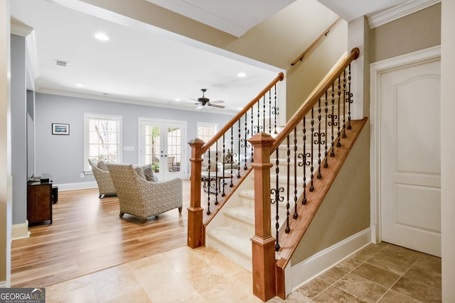 stairs featuring french doors, hardwood / wood-style floors, and crown molding