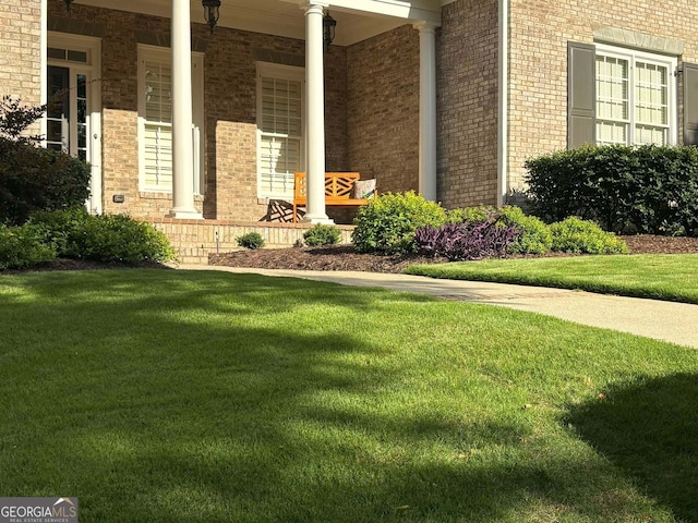 view of side of home featuring a lawn and a porch