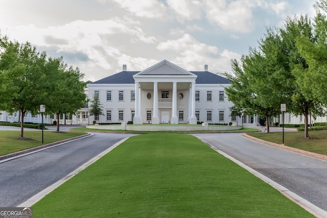 greek revival house featuring a front lawn