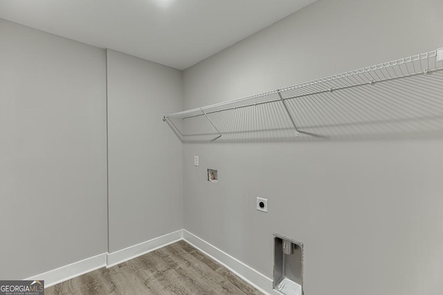 washroom featuring laundry area, baseboards, wood finished floors, washer hookup, and electric dryer hookup