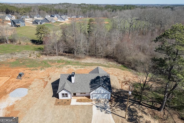 drone / aerial view with a wooded view