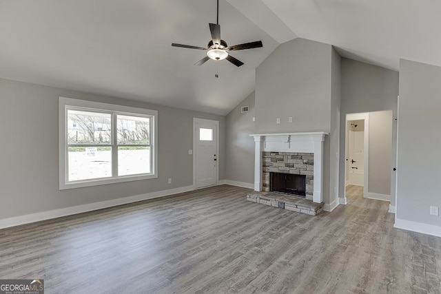 unfurnished living room featuring a fireplace, light wood-style flooring, and baseboards