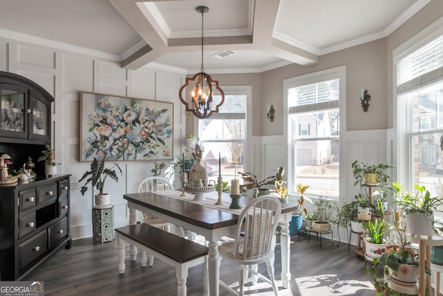 dining area featuring coffered ceiling, dark wood-type flooring, a notable chandelier, and ornamental molding