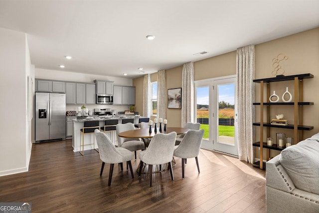 dining area with dark hardwood / wood-style floors