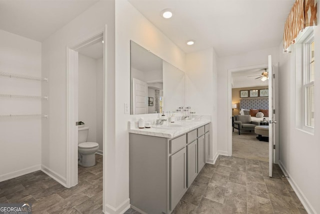 bathroom featuring ceiling fan, vanity, and toilet