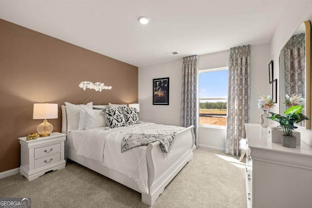 bedroom featuring light carpet