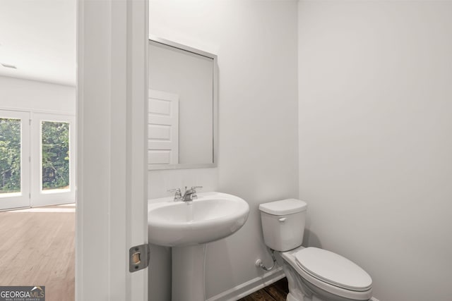 bathroom with sink, toilet, and hardwood / wood-style floors