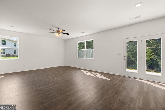 empty room with ceiling fan and dark hardwood / wood-style floors