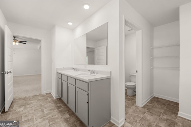 bathroom featuring ceiling fan, vanity, and toilet