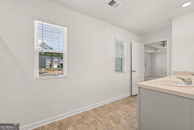 bathroom with hardwood / wood-style floors, ceiling fan, and sink