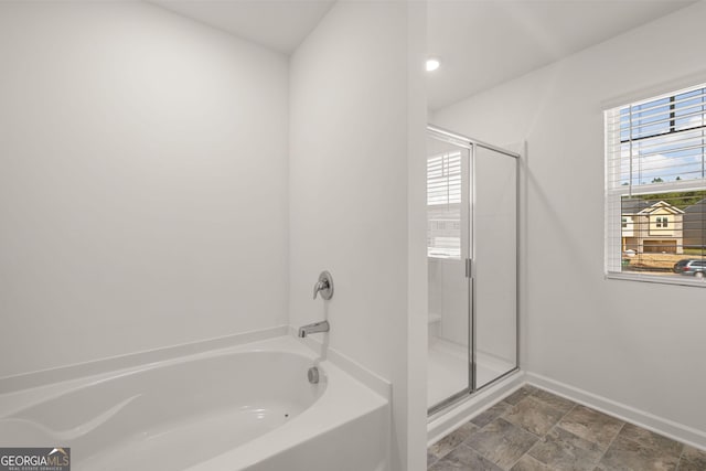 bathroom featuring separate shower and tub and plenty of natural light