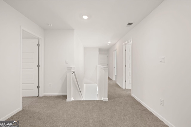 unfurnished room with light colored carpet