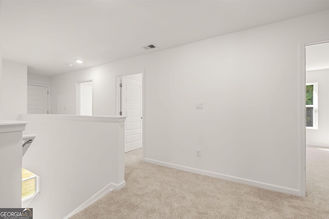 spare room featuring light colored carpet