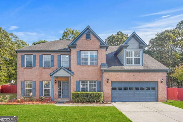 view of front of home with a garage and a front lawn