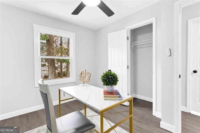 office featuring dark wood finished floors, a ceiling fan, and baseboards