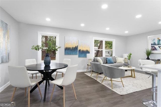 dining area with dark wood-style flooring, plenty of natural light, and recessed lighting