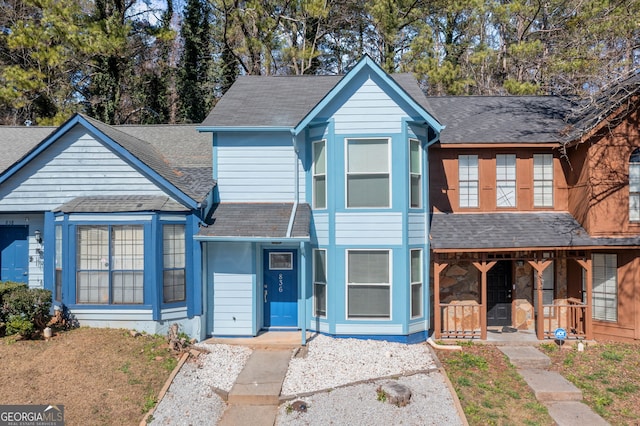 view of front of property featuring a shingled roof and a porch