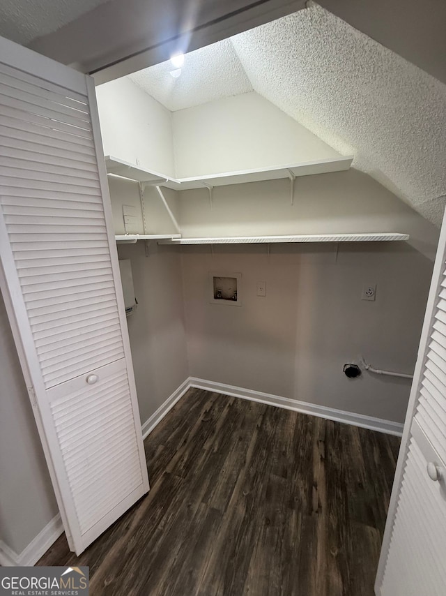 washroom with a textured ceiling, washer hookup, dark hardwood / wood-style flooring, and electric dryer hookup