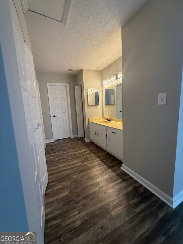 bathroom featuring hardwood / wood-style floors, a textured ceiling, and vanity